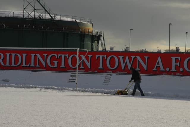 An optimistic groundsman marks out the lines on the pitch at Bridlington Town's ground.