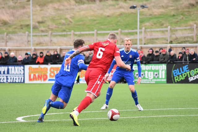 Josh Lacey closes down a Farsley attacker