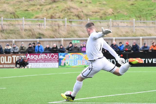 Tommy Taylor launches the ball upfield