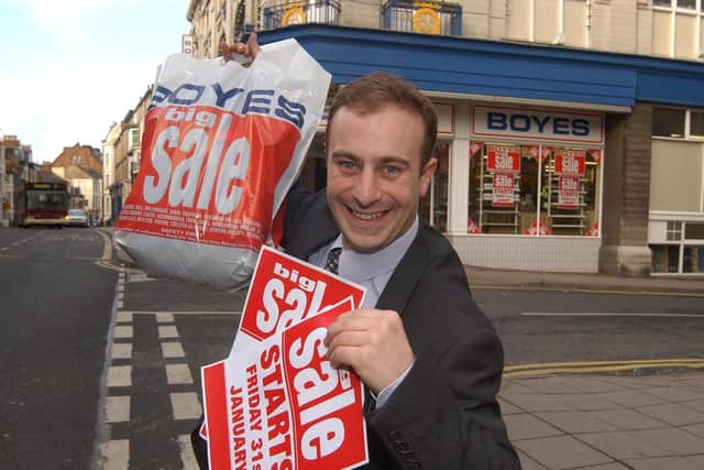 Store manager Matthew Boyes tries to tempt shoppers ahead of the winter sale in 2003.