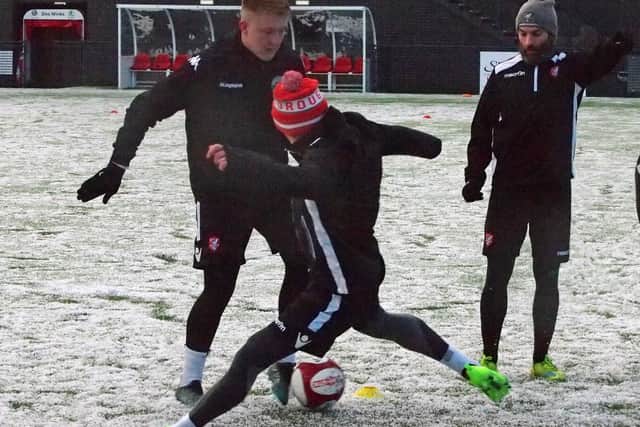 Boro players compete for the ball in the snow