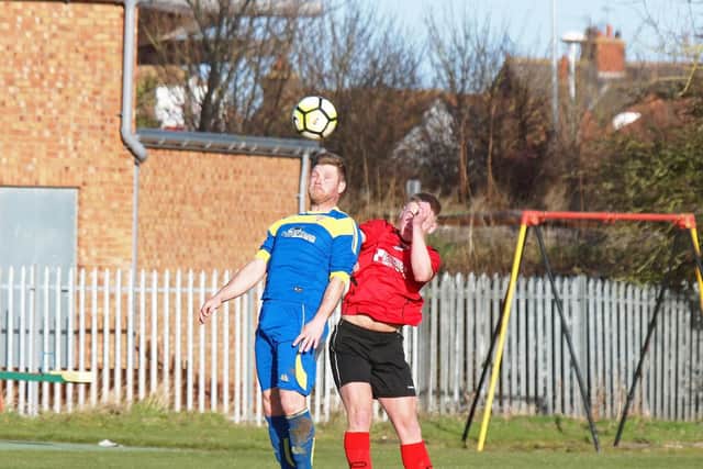 Seamer player-boss Tommy Adams contests a header with a Filey man