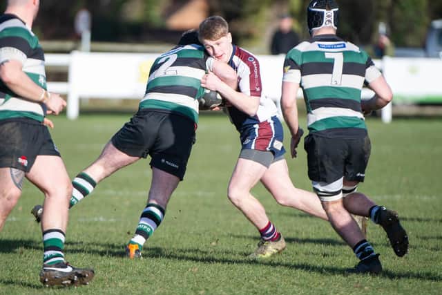 Euan Govier tries to barge through a York opponent