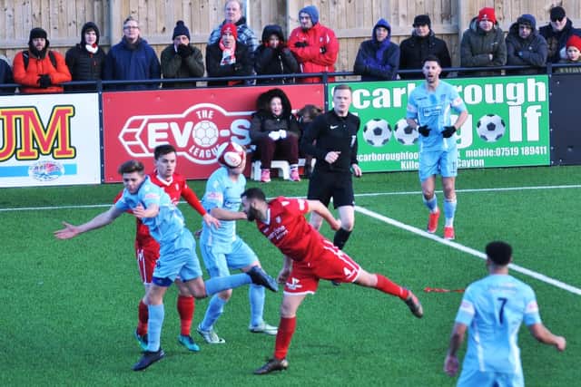 The returning Luke Dean gets his head to the ball