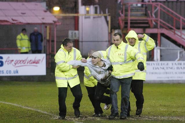..... and is then escorted from the ground