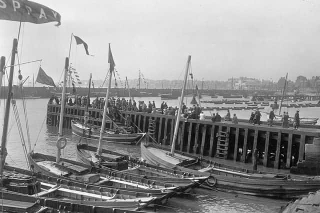 People disembarking from one of the boats moored in Bridlington harbour in August 1926.