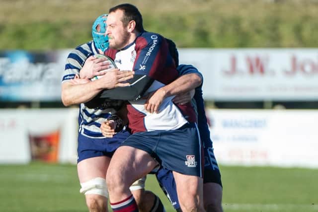 Tom Ratcliffe tries to fend off two Pock opponents