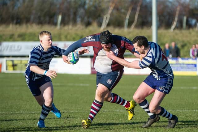 Skipper Matty Jones tries to fend off two Pocklington players