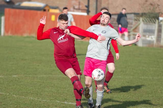 Angel's Dom Barber battles for the ball with Saints' Josh Valancius