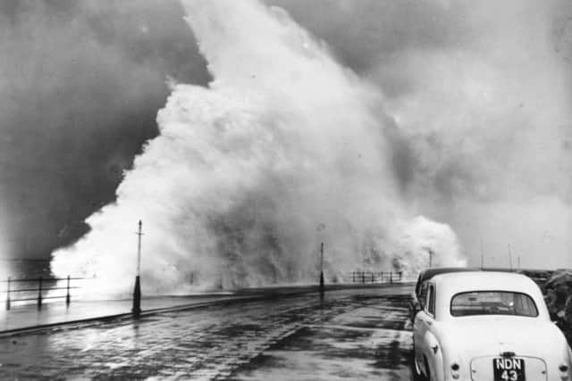 Waves foamed 40-50 feet into the air over Marine Drive.