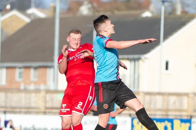 Josh Lacey contests a header