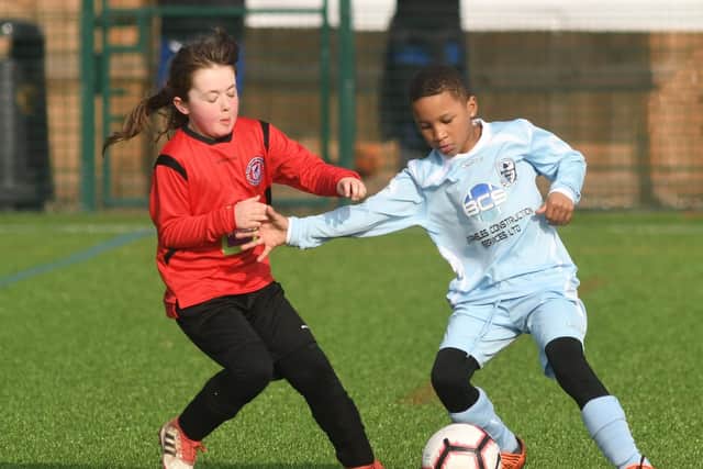 Burlington Jackdaws Daisy Slater goes in for a tackle v Bridlington Rangers Spitfires under 10s