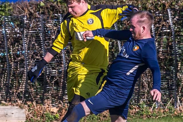 Carl Hepples challenges keeper Dylan Humble