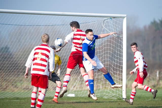 Traf player-boss Joel Ramm contests a header