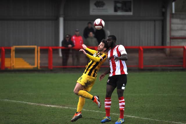 Luke Lofts tries to win a header