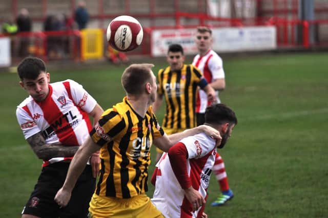 James Walshaw flicks a header on