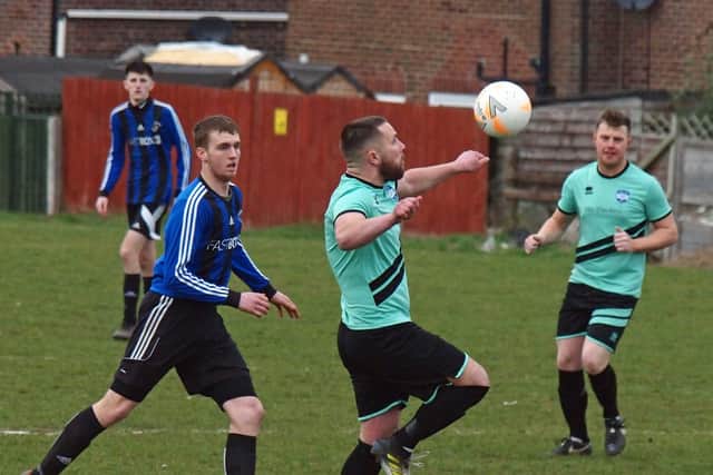 Sean Bloom on the ball for Itis Itis Rovers