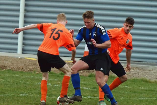 Snainton's Nathan Barber is put under pressure