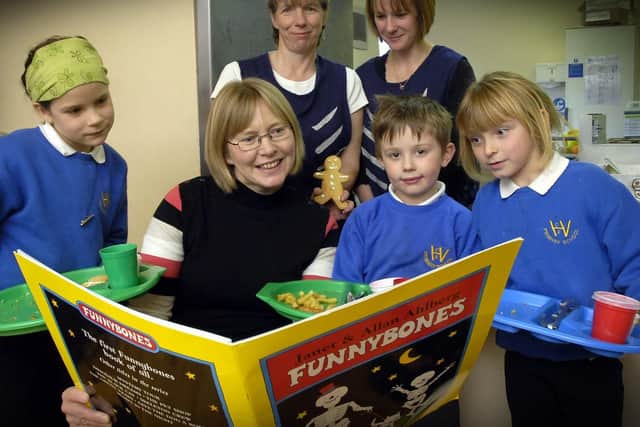 Dinner ladies Judy Bulman and Sue Bedford joined in with Funny-bones outfits and gingerbread men. Front headteacher Trina Price, reads to pupils Becky Green, 8(L), William Barker, 6 and Leah Boyes, 5.