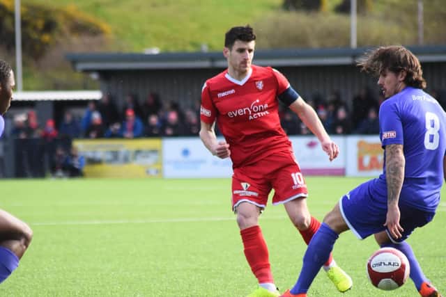 Michael Coulson nutmegs his man