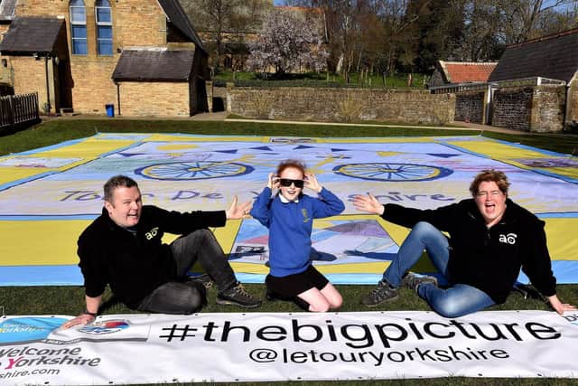 Lee Threadgold and Dawn Dyson-Threadgold join design winner Libby Graham  at Wykeham School for the Tour de Yorkshire land art revea. Picture: Richard Ponter