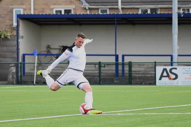 Tommy Taylor clears the ball