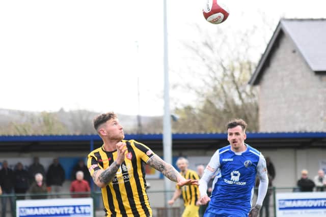 Kev Burgess wins a header