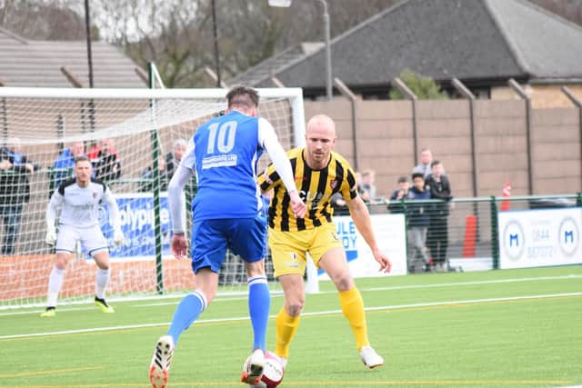 Ross Killock looks to nick the ball