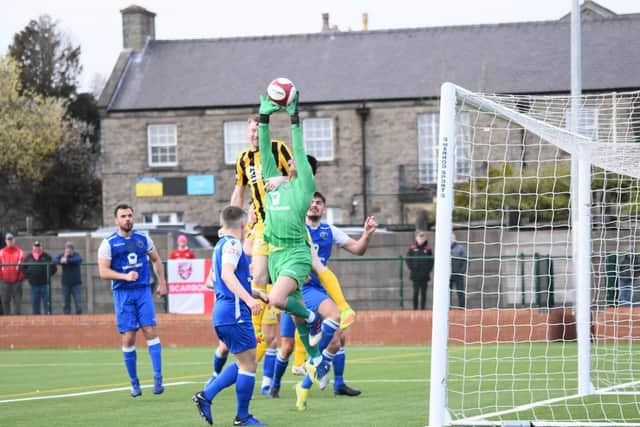 James Walshaw challenges the keeper