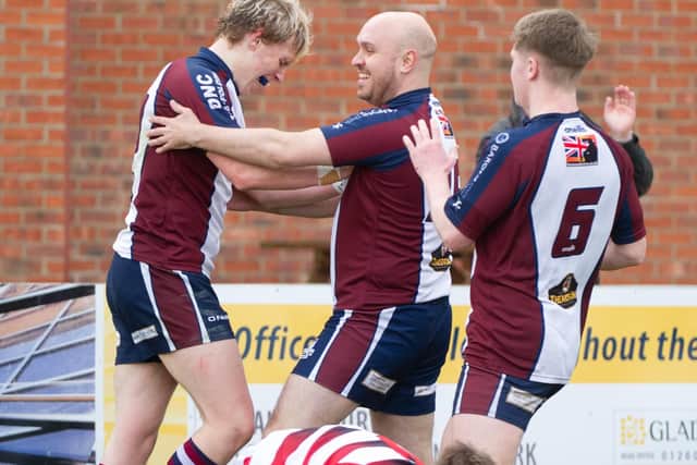 Aaron Wilson is congratulated after touching down