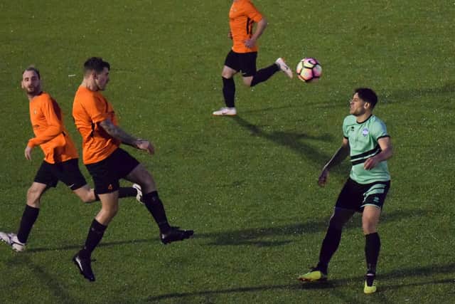 Dan Jones heads clear with Pickard at close quarters