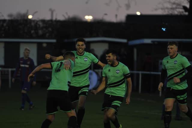 Jack Ramos is mobbed after his goal