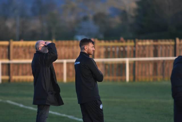 Boss Mike Barker looks on