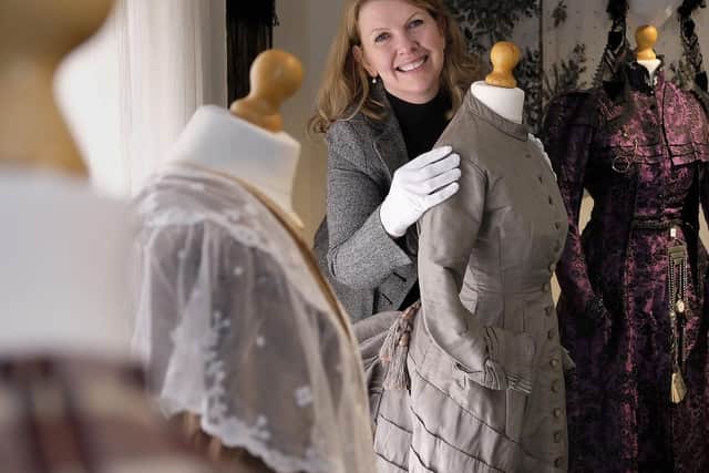 Volunteer and costume specialist Michele Conway with the Victorian  costume exhibits