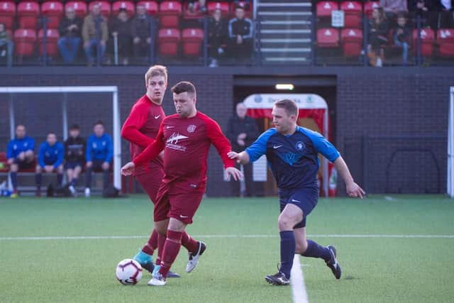 The sides battle for the ball in midfield