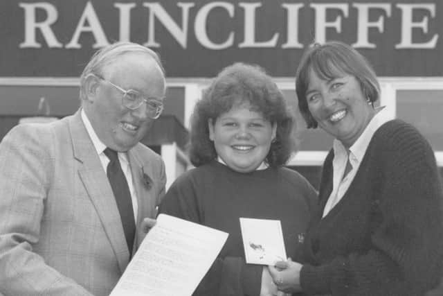 Raincliffe School girl Kim Green received a top award in November 1995 after writing an essay on the North York Moors. She is pictured receiving her award from school governors John Bennett and Joan Briggs.