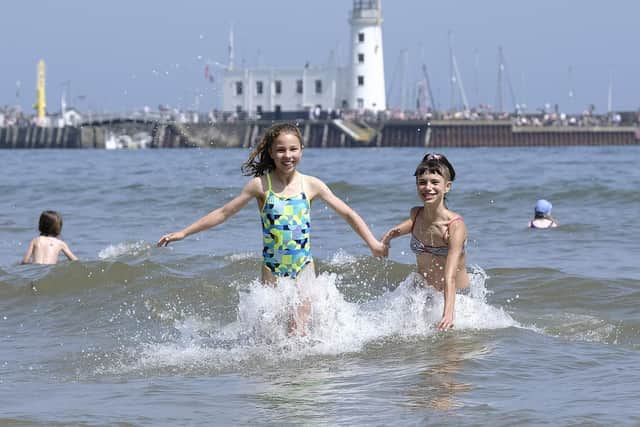 The weekend heatwave hits Scarborough as Louisa and Sophia cool off in the sea.