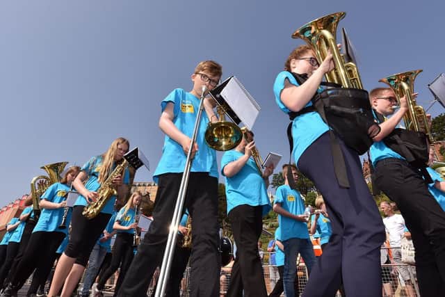 One of the bands marching along South Bay.