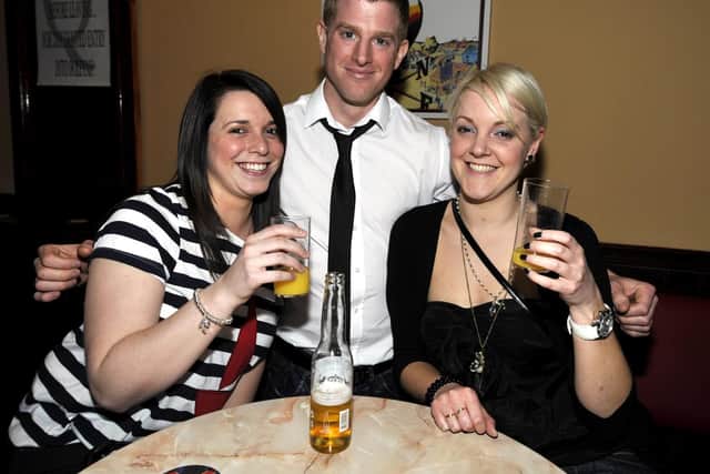 Three friends enjoy a pint.