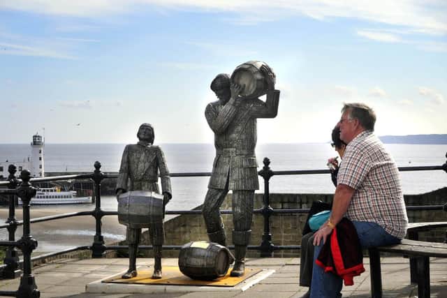 This sculpture was installed in 2012 and depicts a young apprentice struggling to lift a barrel while the smuggler does so with ease.