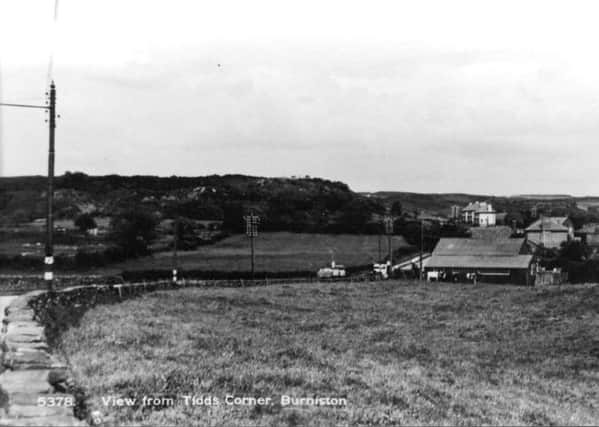 Taken from Burniston High Street, this view looking towards Cloughton shows the curve of Mill Lane as bends awy into the distance. The bend is know locally known as Tidds Corner.
Tidds Corner is on Scarborough and District and Arriva bus routes and appears on their respective timetables.
Photo reproduced courtesy of the Max Payne collection. 
Reprints can be ordered with proceeds going to local charities. Telephone 0330 1230203 and quote reference number