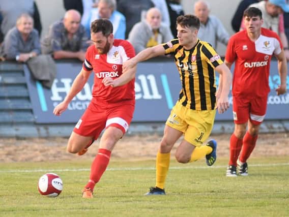 Chris Jenkinson clears from Will Annan