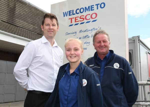 Pictured are  Giles Baugh (store manager), Yasmin Leech and Donovan Copley