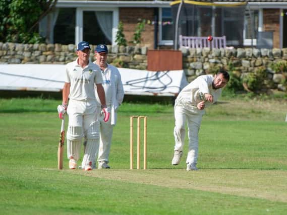 Sherburn's Ben Briggs turns his arm over at Cloughton. Picture by Andy Standing.