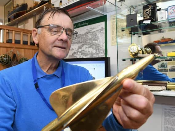 Scarborough Maritime Heritage Centre volunteer John Ives pictured with some of the items on display