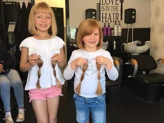 Sophie Spencer and Maddison Hardcastle with their chopped-off locks.