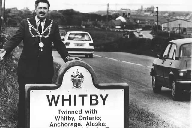 Reg Firth unveiling a new sign in his time as Whitby mayor