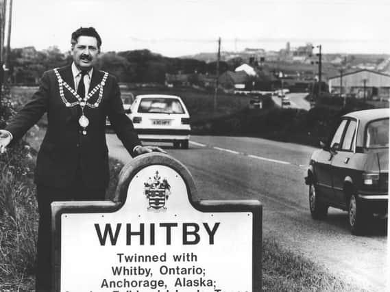 Reg Firth unveiling a new sign in his time as Whitby mayor