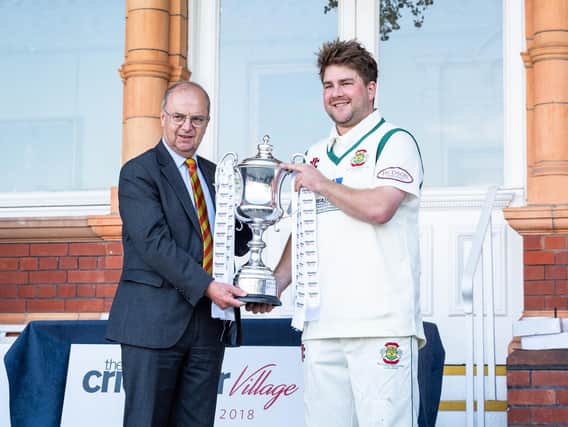 Flixton skipper Will Norman receives the trophy. Picture by Will Palmer.