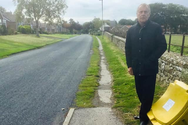 Cllr Derek Bastiman stands at the start of the stretch of footway that is to be upgraded.